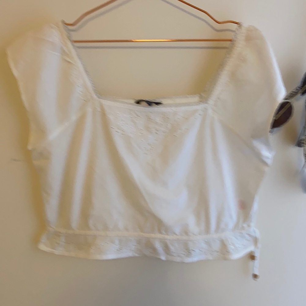 White midriff top with off the shoulders sleeves.